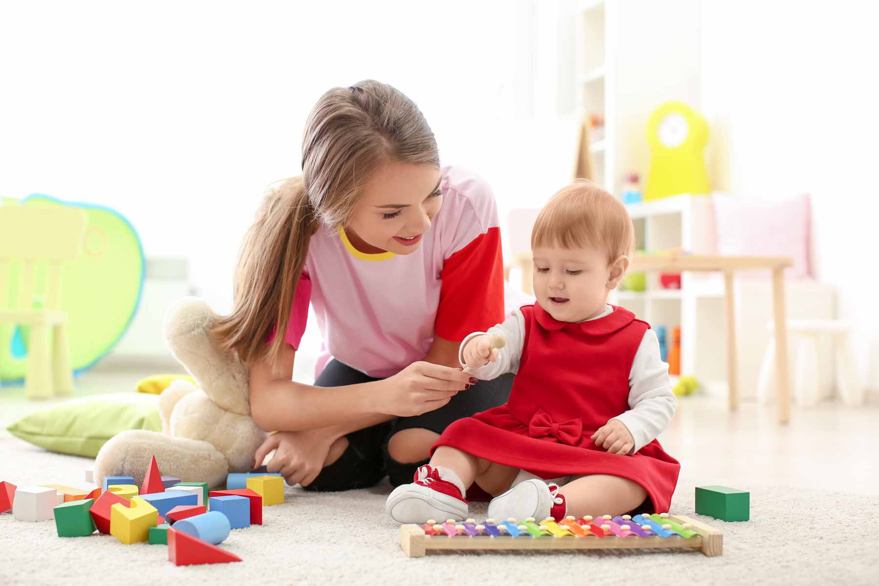 An au pair playing with a young child.