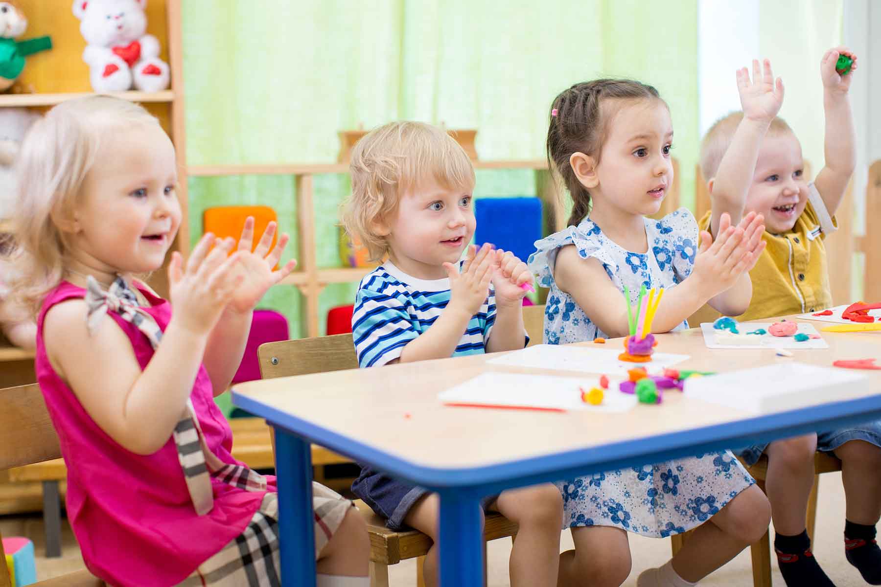 A happy group of children learning arts and crafts in a daycare center A happy group of children learning arts and crafts in a daycare center