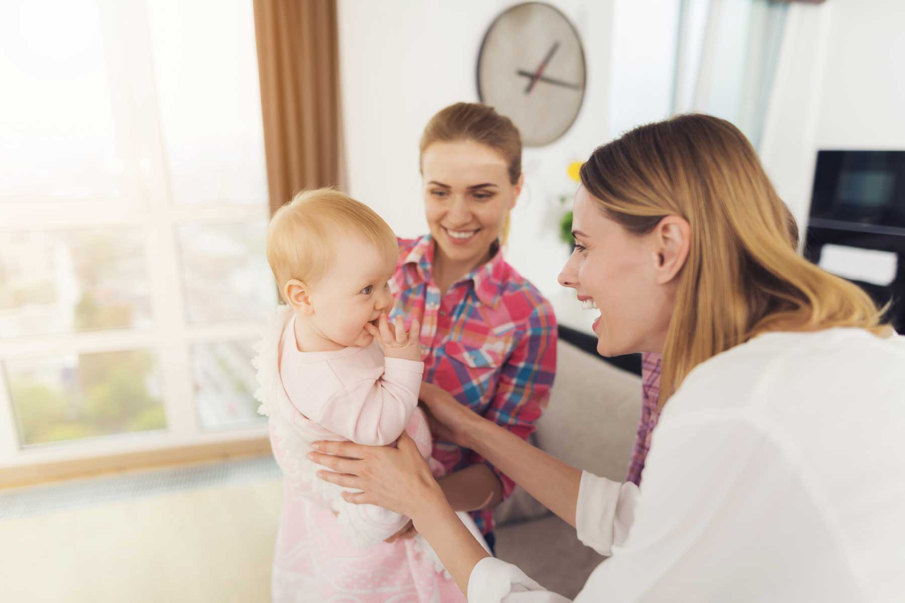 A babysitter meeting the mother and her young child.