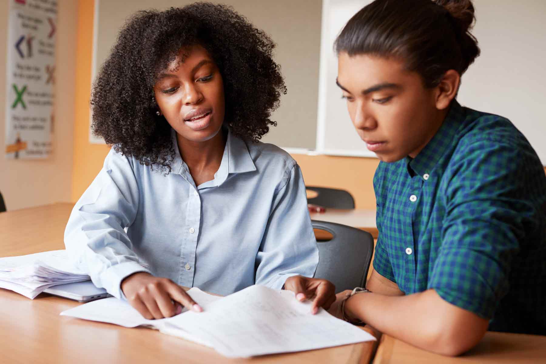 A tutor helping a student learn math