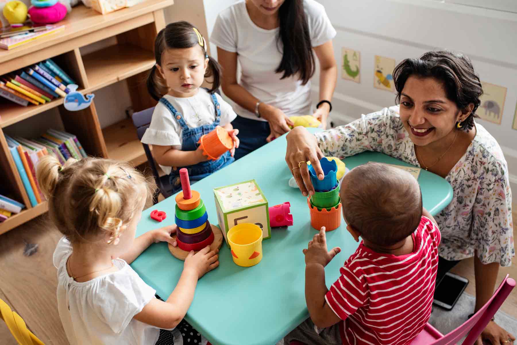 Children playing with toys on a table at a daycare center