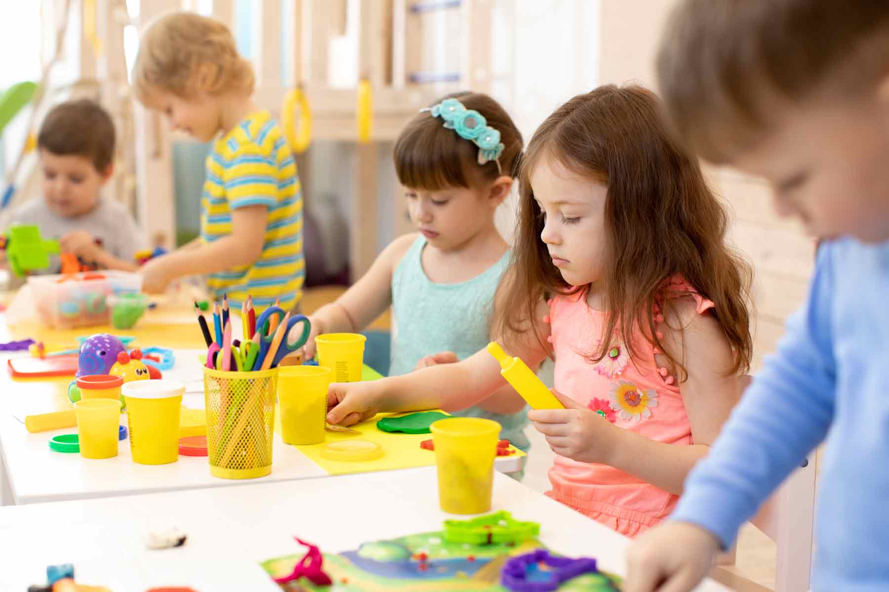 Young children working on arts and crafts in day care.