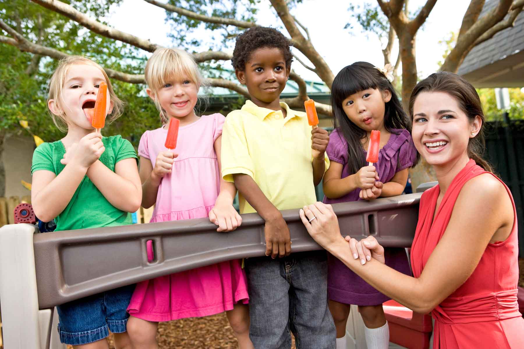 A nanny caring for children from different families as part of a nanny share arrangement.