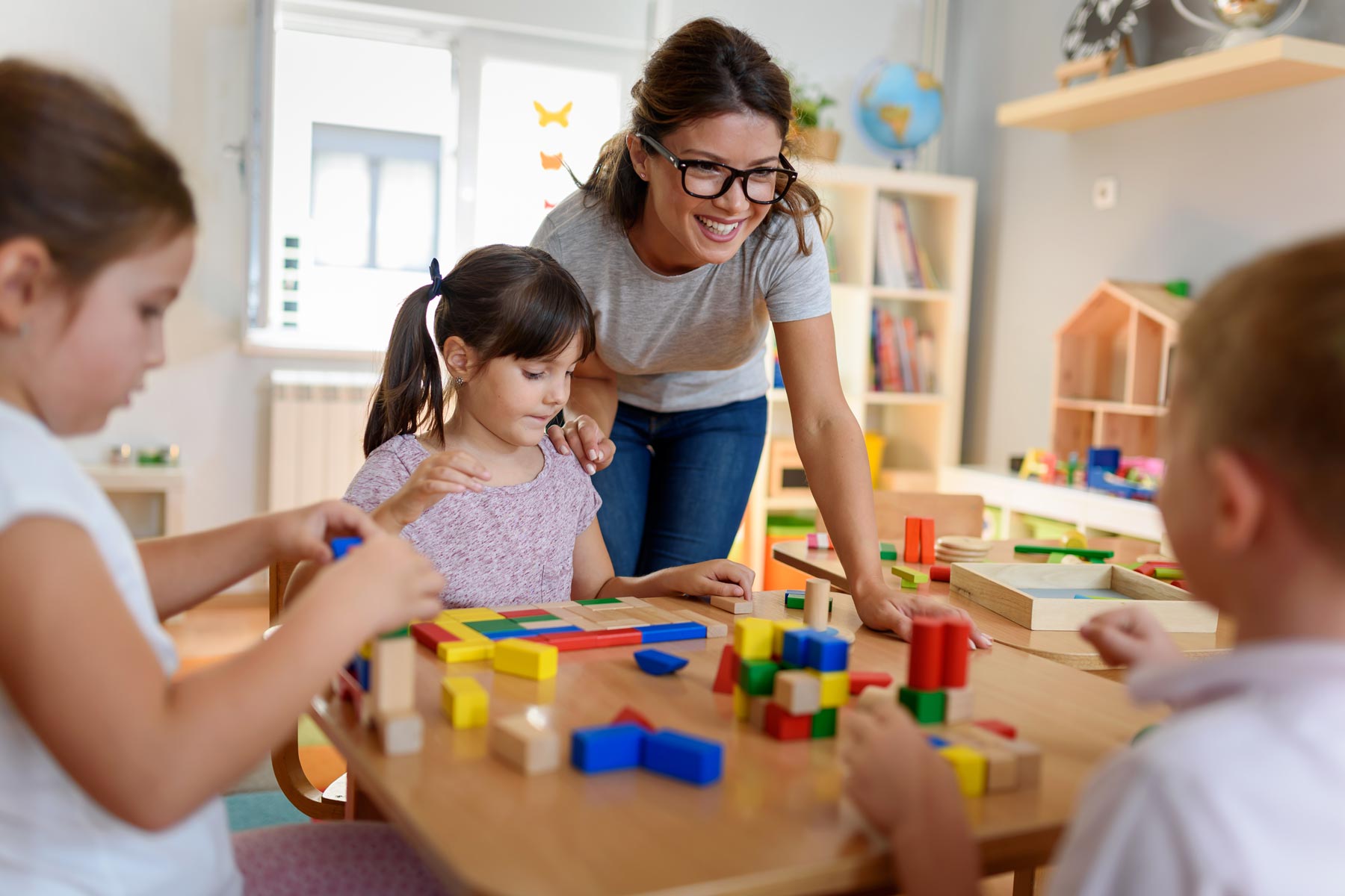 Teacher and kids at toddler daycare and preschool centers 