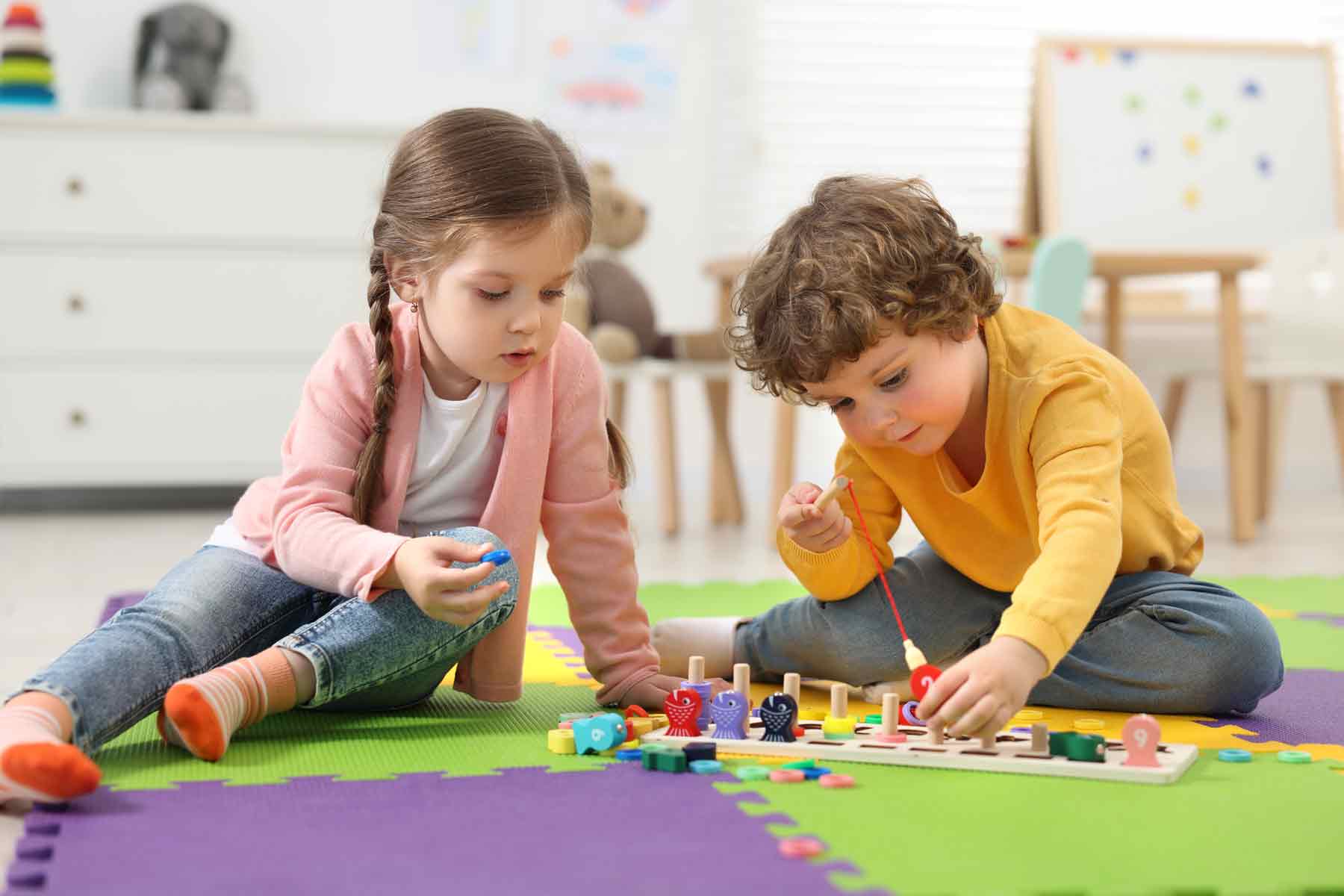 Two children playing with toys at a daycare center