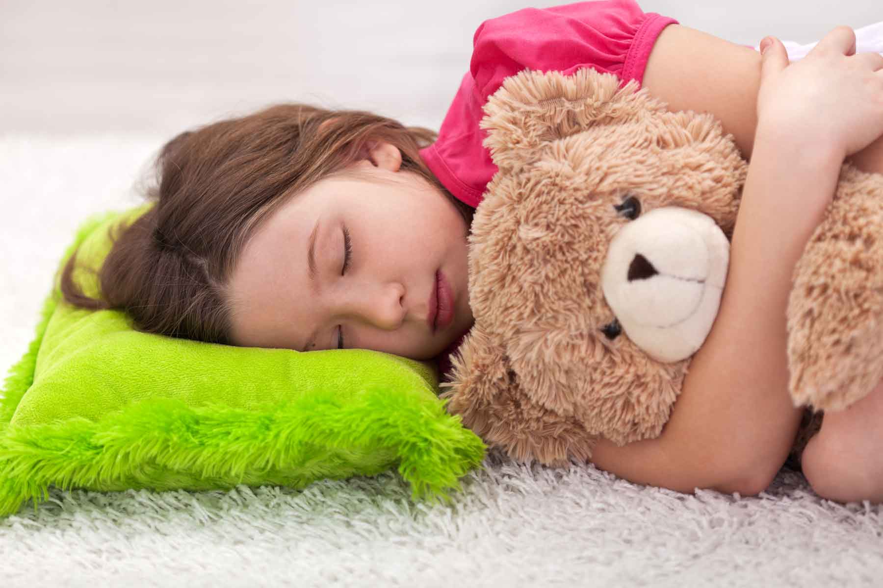 A young girl sleeping at a daycare center